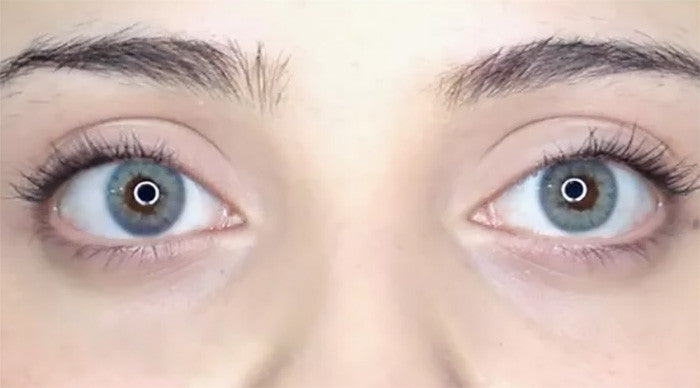 April Blue colored contacts by Urban Layer in flash/bright light