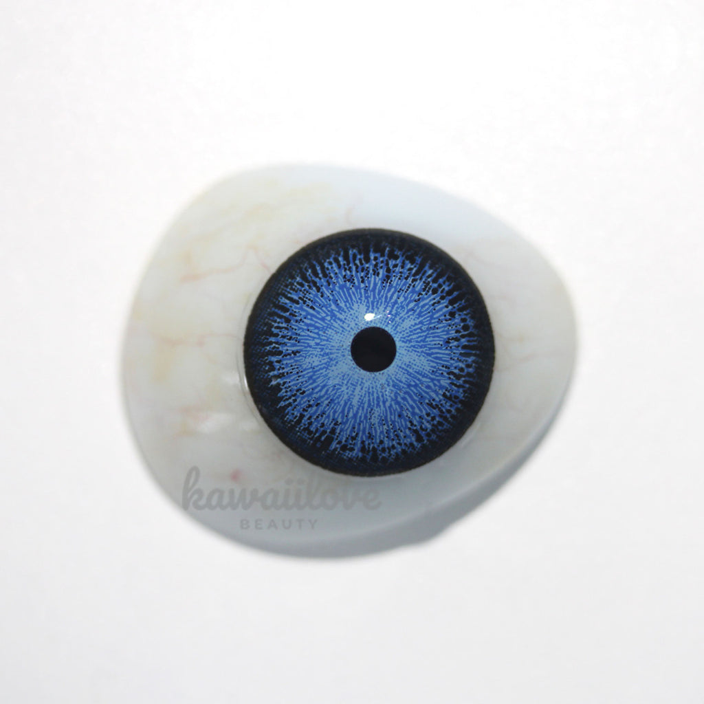 Interstellar Blue colored contact lens displayed over model of dark brown eye. These vibrant blue circle lenses ship fast from the United States.