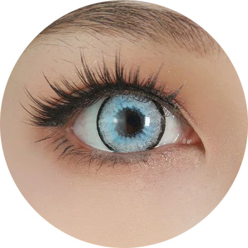 A close-up circular crop of a human eye wearing a light blue contact lens, with long dark eyelashes and pale skin around it on a white background. Main image