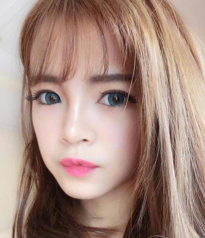 Puffy 3 Tones Turquoise circle lenses by Dueba Barbie over brown eyes in natural light