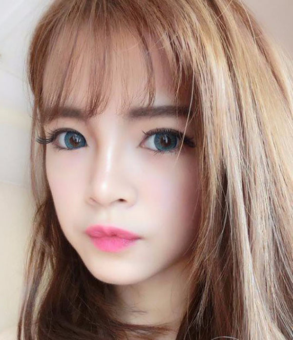 Puffy 3 Tones Turquoise circle lenses by Dueba Barbie over brown eyes in natural light