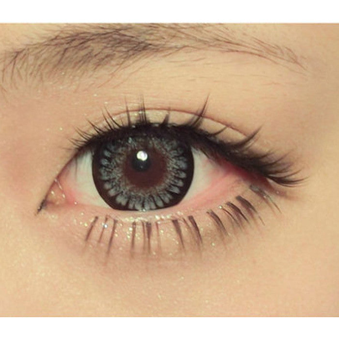 Closeup on Princess Mimi Grey circle lens on brown eye.