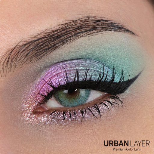 Close-up of an eye with colorful makeup and 'Urban Layer' branding.